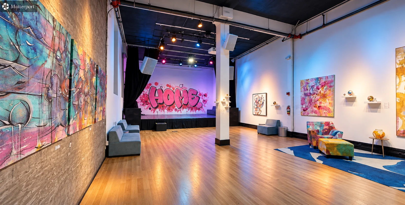 Wide view of the Zappa Room floor, lounge seating and stage.